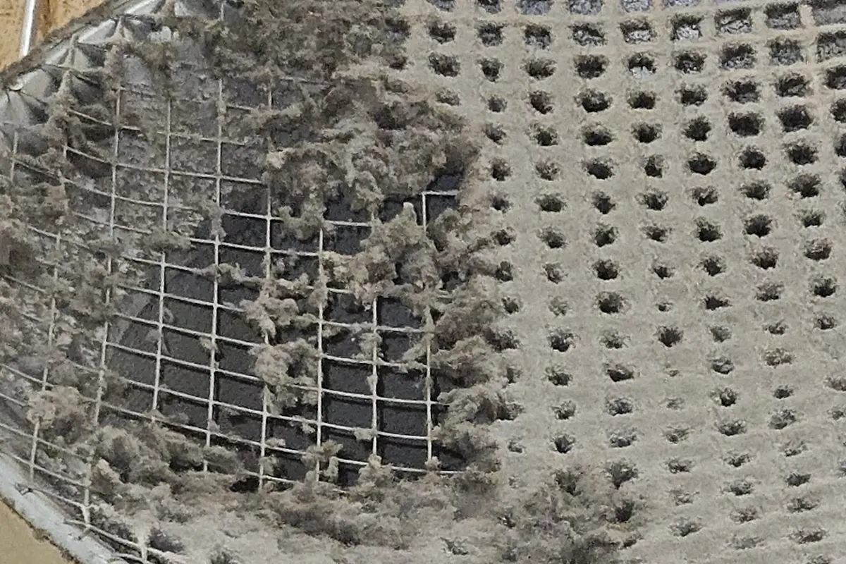 Before: Mesh on a duct opening: dust clogging the holes